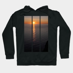 Wonderful landscapes in Norway. Nord-Norge. Beautiful scenery of a midnight sun sunset at Nordkapp (Cape North). Boat and globe on a cliff. Rippled sea and clear orange sky. (vertical) Hoodie